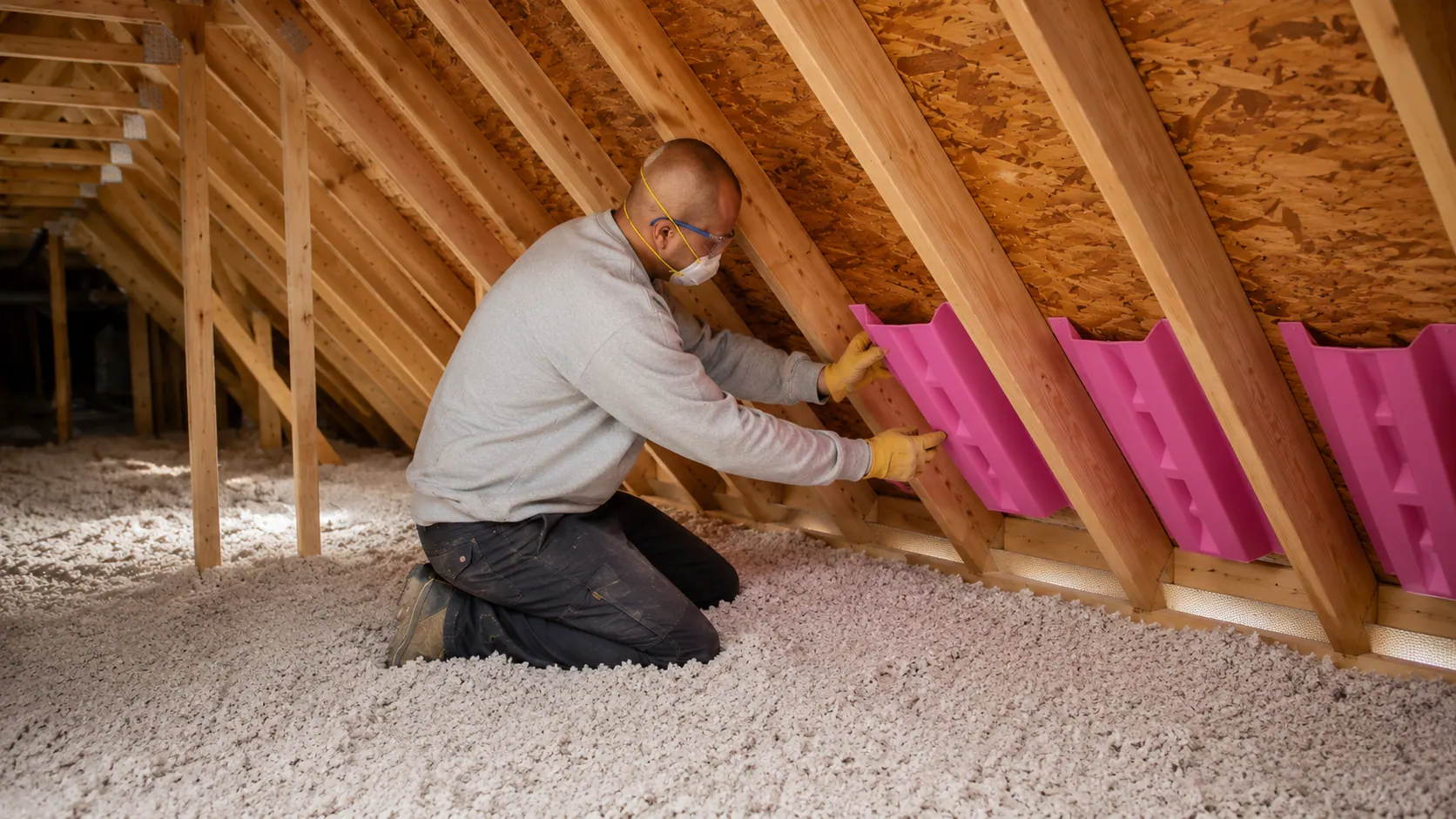 Batt insulation being fitted between framing members